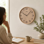 Standuhren.com 🕰️ AMS F5514 Funkwanduhr mit hellem Holzgehäuse und schwarzem Ziffernblatt in modernem Wohnzimmer